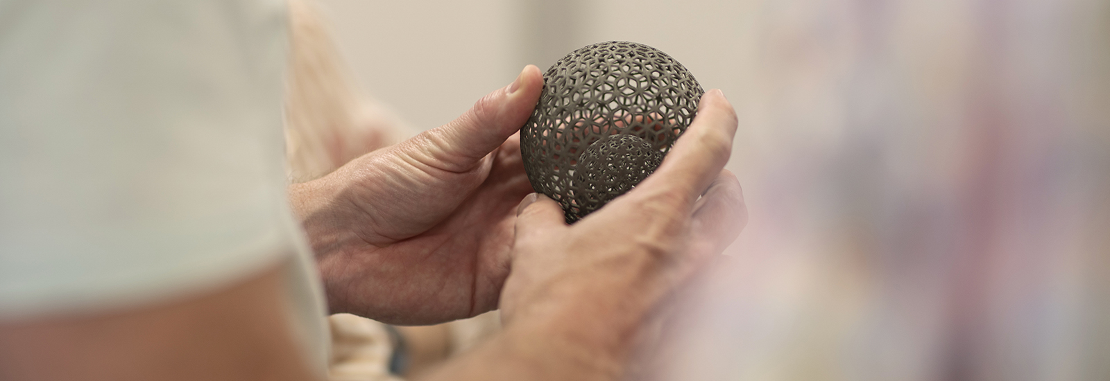 student showcasing 3d printed sphere