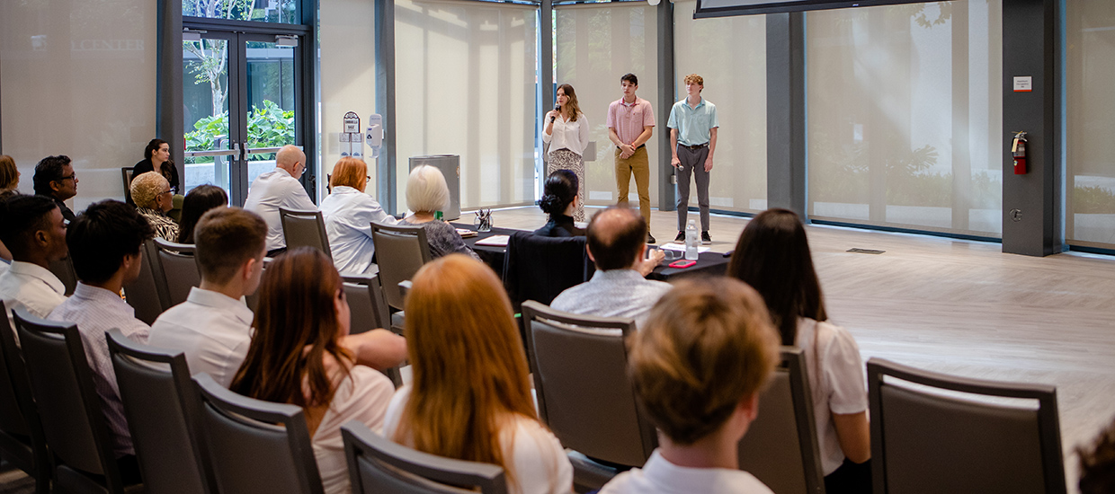 Students presenting their work in front of a panel